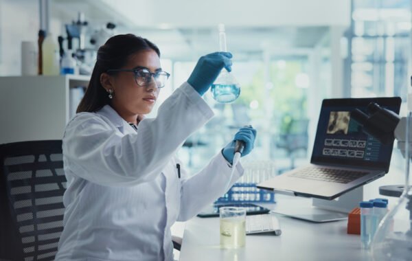 Scientist, woman and beaker with pipette for chemistry, testing and medical research. Biotech, laboratory and analysis with data inspection for pharmaceutical or pathology experiment for breakthrough.